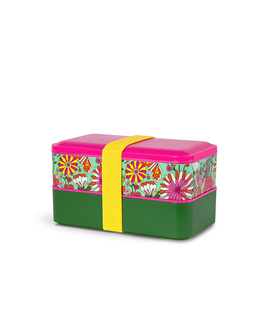 side view of two plastic stacking bento boxes with hot pink lid, mint floral print, and dark green solid. both wrapped with yellow elastic