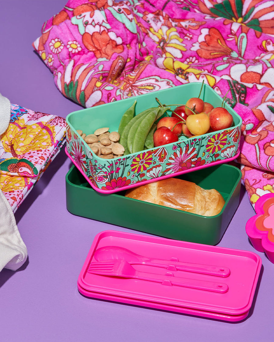 editorial image of bento lunch box with reusable utensils and filled with lunch food.