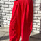 model wearing red draped relaxed fit pants