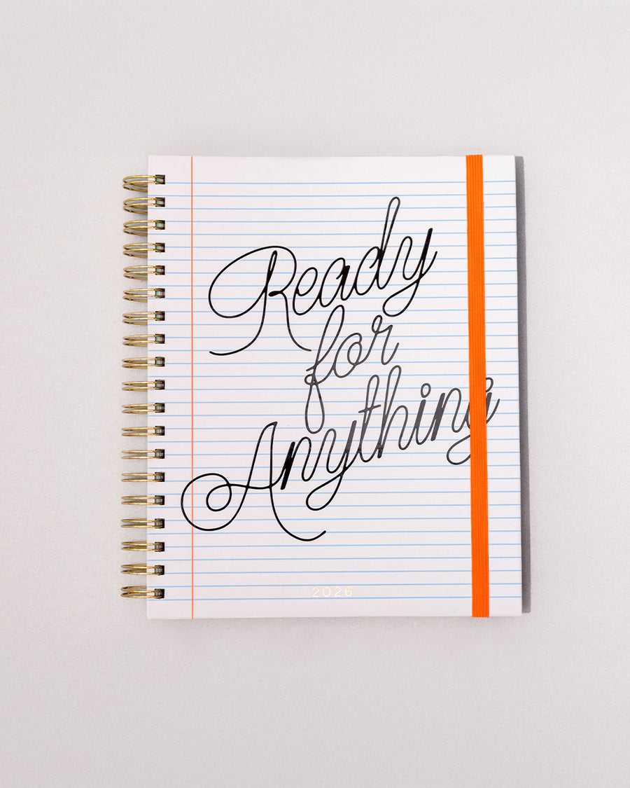white lined paper large 12-month planner with cursive 'ready for anything' font and orange elastic closure