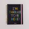 black 12-month planner with colorful 'i'm thrilled to be here' and pink elastic closure