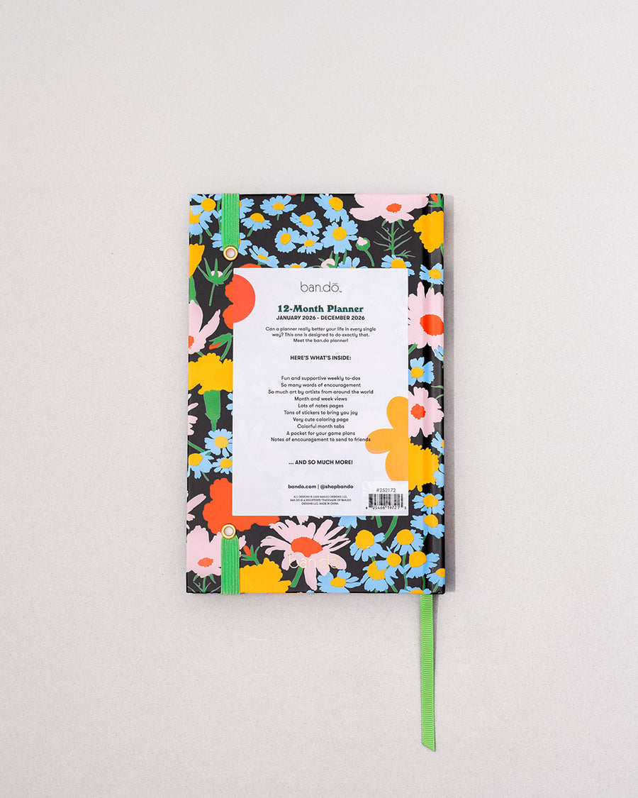 back view of black 12-month classic planner with green elastic closure and bookmark with all over colorful floral print
