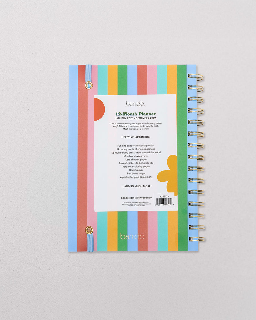 back view of cream medium annual soft cover 12-month planner with colorful block lettered 'let's have some fun.' typography with light blue elastic closure