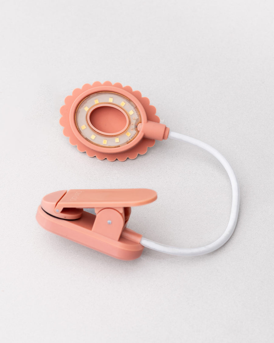 bottom view of pink book light with pink and cream 'do not disturb! reading in progress!' on the top of the light