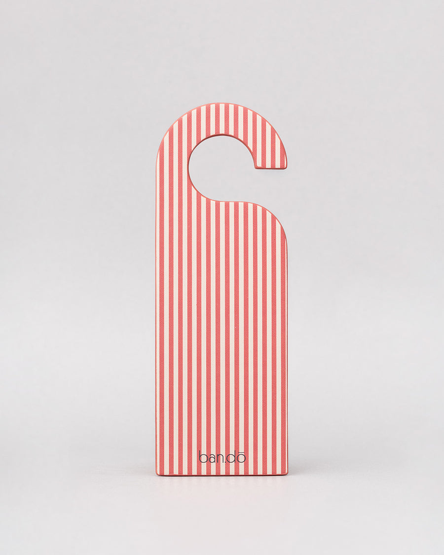 back pink and white vertical stripe of pink bookmark in the shape of a door hanger with white 'do not disturb! book reading in progress' across the front