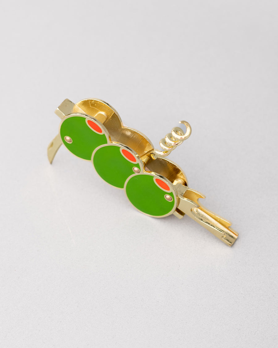 top view of gold pocket corkscrew with three green olives