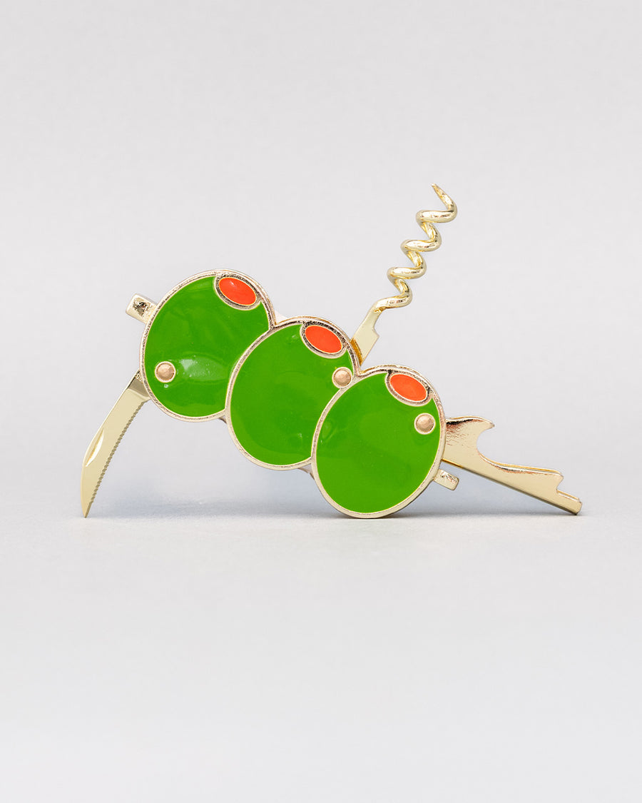 sideview of opened gold pocket corkscrew with three green olives