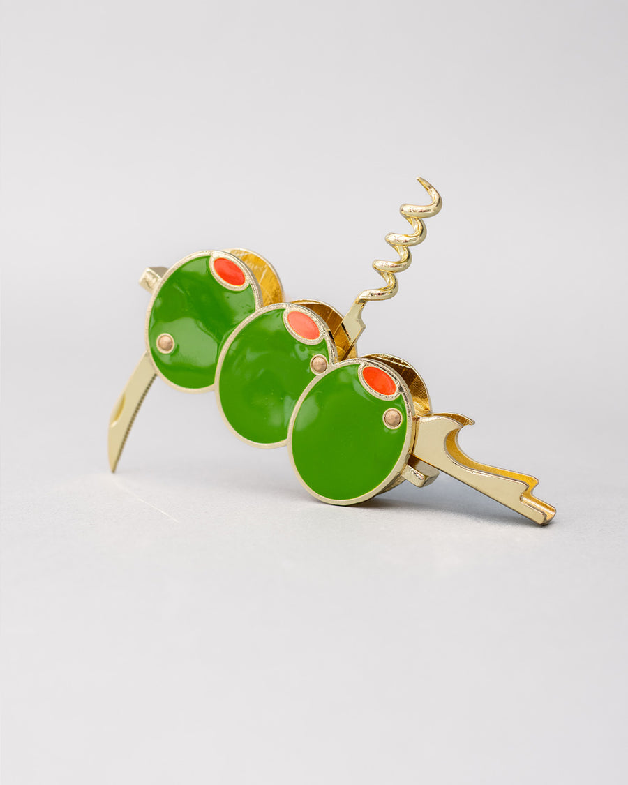 opened gold pocket corkscrew with three green olives