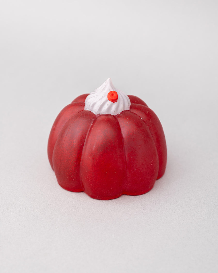 pink jello mode de-stress ball with white whipped topping on top