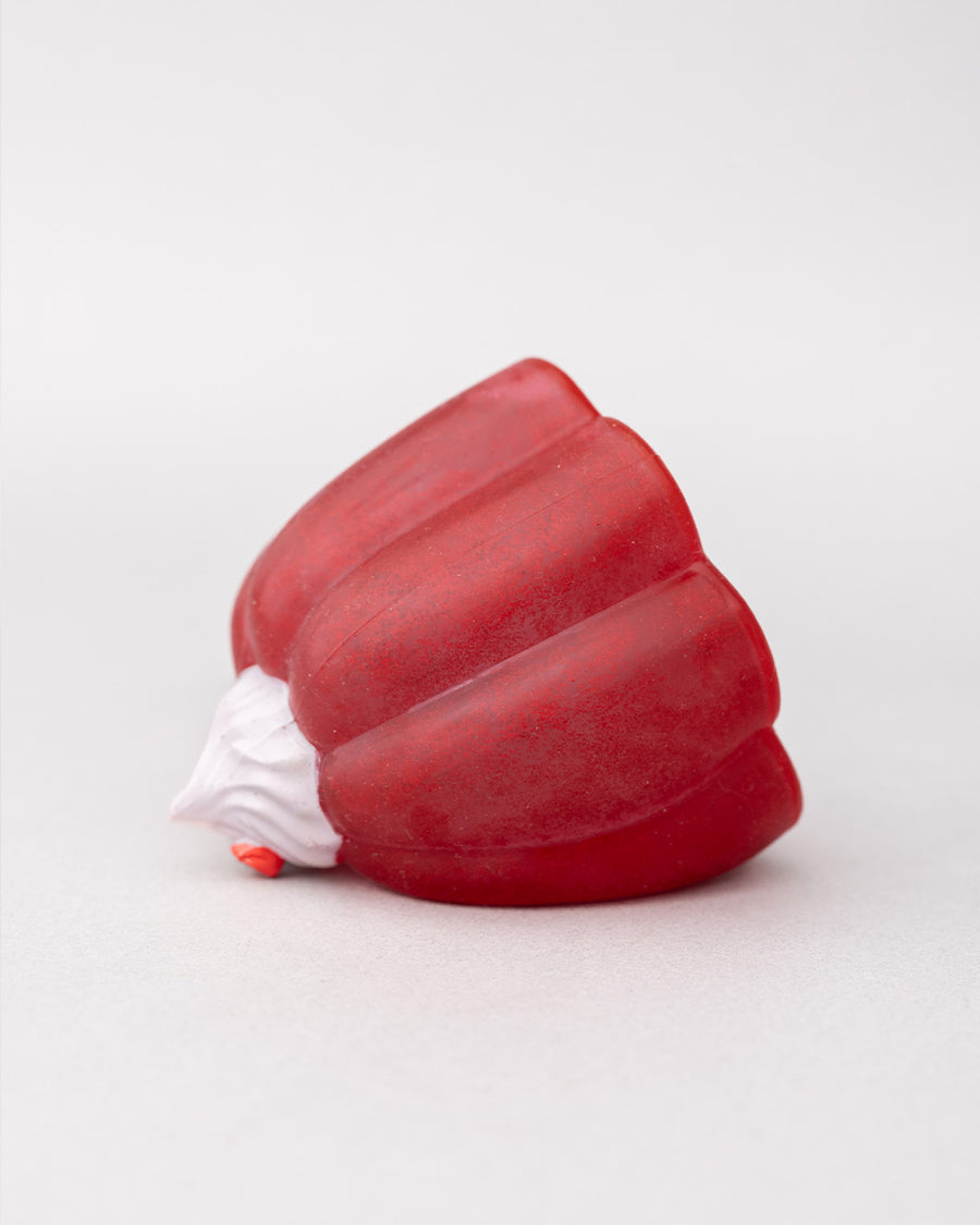 tipped over pink jello mode de-stress ball with white whipped topping on top
