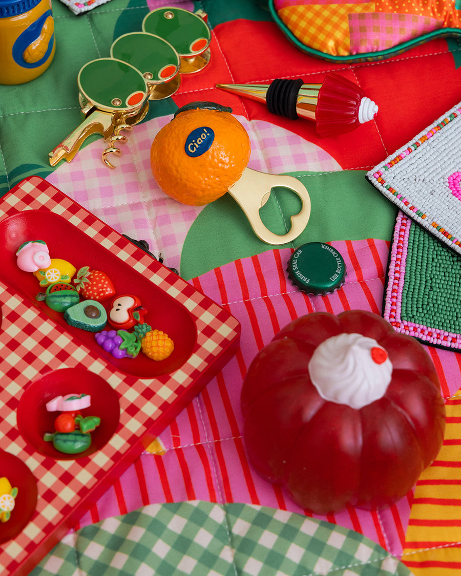 pink jello mode de-stress ball with white whipped topping on top surrounded by colorful items