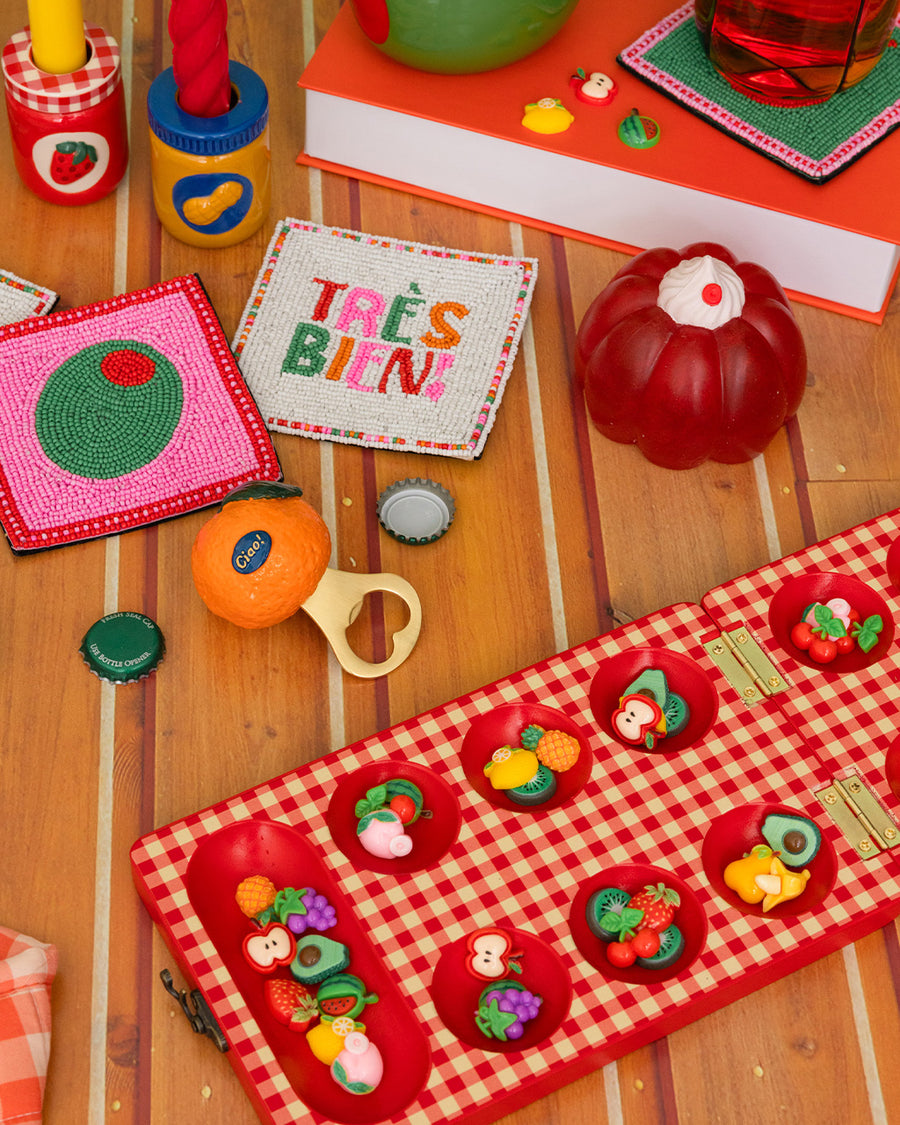 pink jello mode de-stress ball with white whipped topping on top next to colorful items