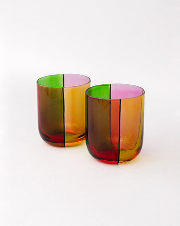 side view of set of two low ball glass set with four colors sections: pink, green, orange and red