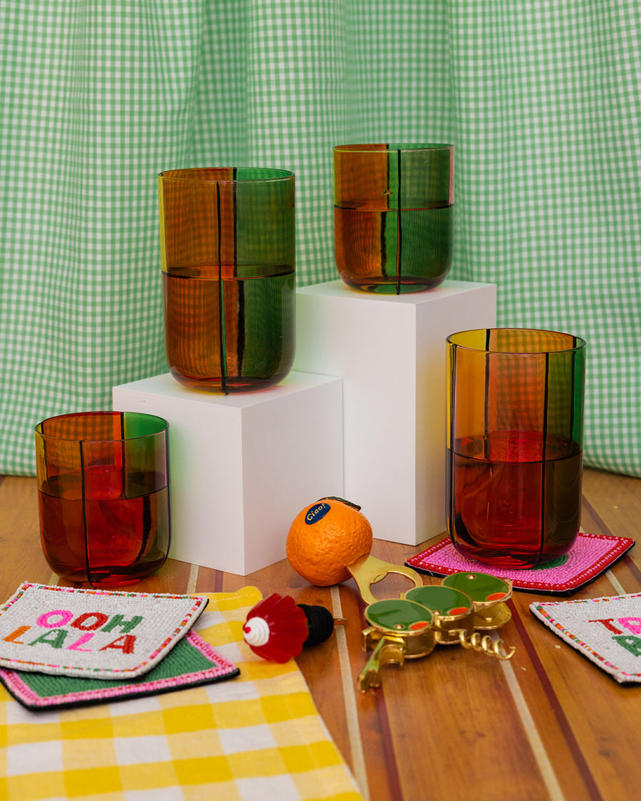 set of two low ball glass set with four colors sections: pink, green, orange and red with high glass set, and various colorful kitchen items