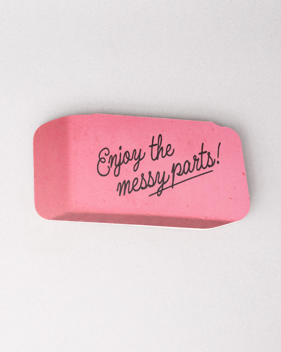 realistic eraser notepad with 'enjoy the messy parts' across the front