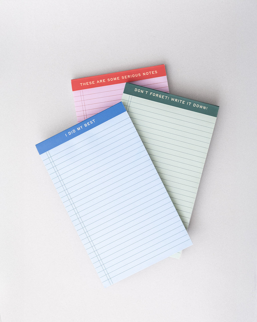 set of three ini legal pads: red/pink with 'these are some serious notes' on the top, green with 'don't forget! write it down!' and blue with 'i did my best'