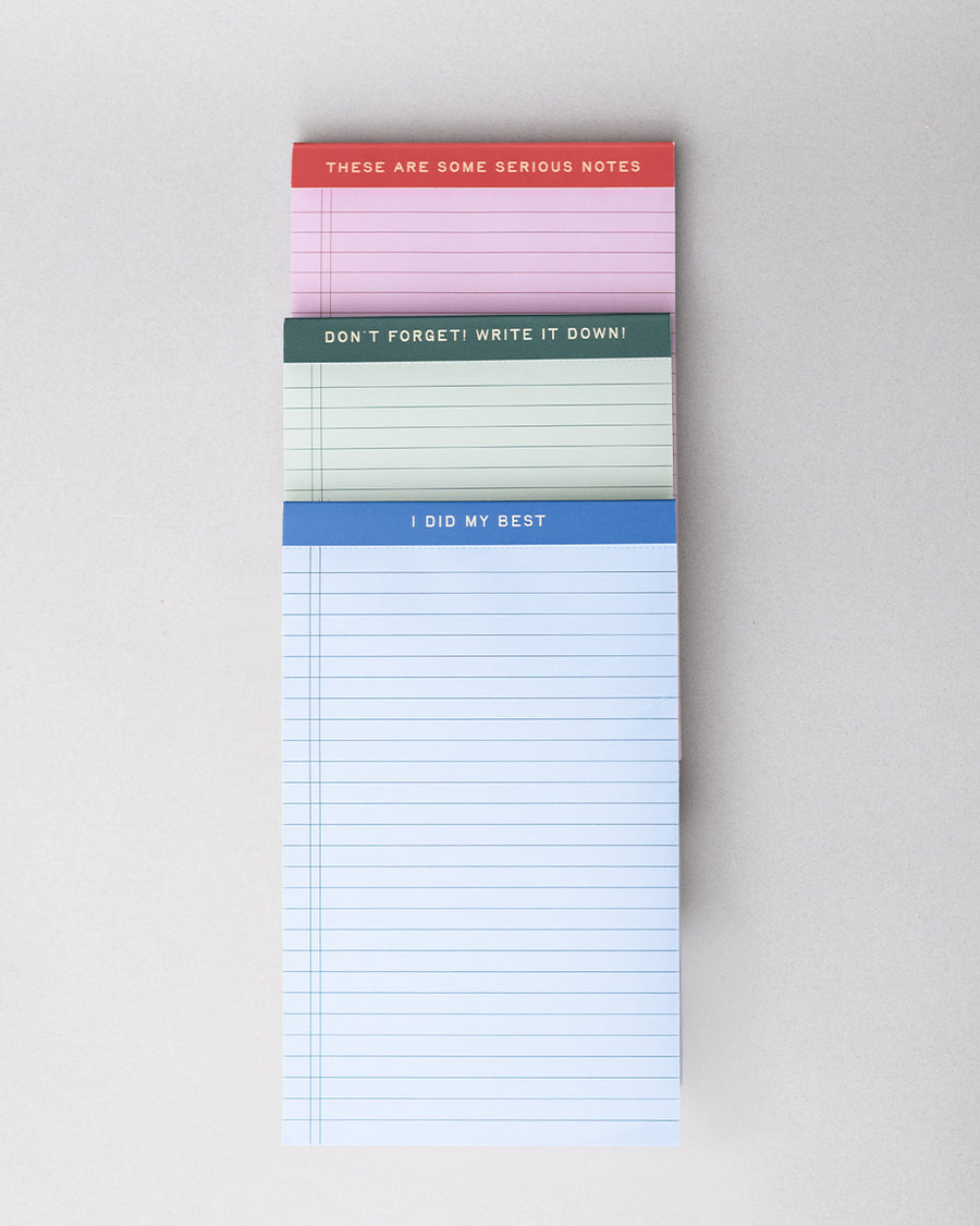 set of three ini legal pads: red/pink with 'these are some serious notes' on the top, green with 'don't forget! write it down!' and blue with 'i did my best' stacked on each other