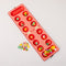 top view of red and cream gingham mancala board with colorful fruit game pieces