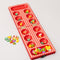 Wooden Mancala board game with colorful fruit-shaped pieces arranged across a printed board.