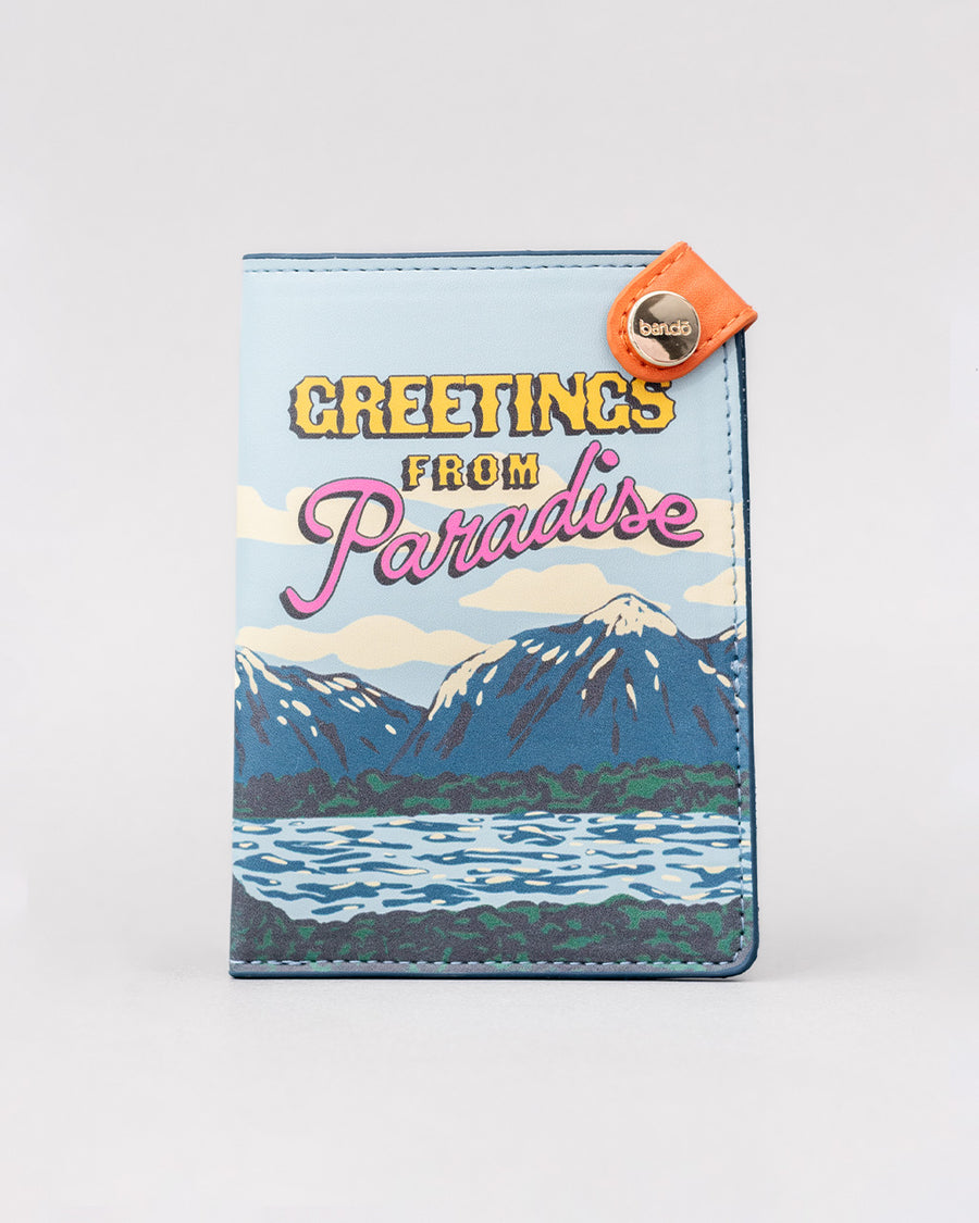 passport holder with colorful mountain scene and 'greeting from paradise' across the front