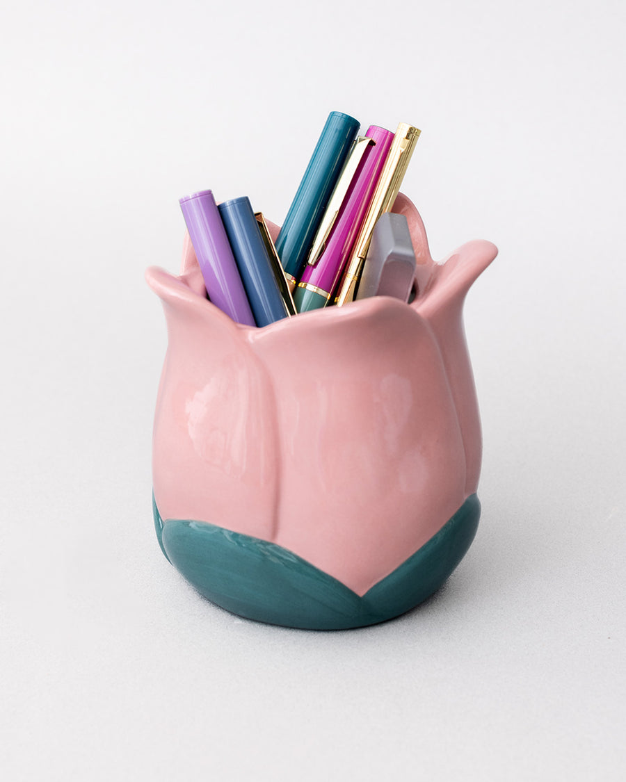 light pink tulip shaped pencil holder with pens inside
