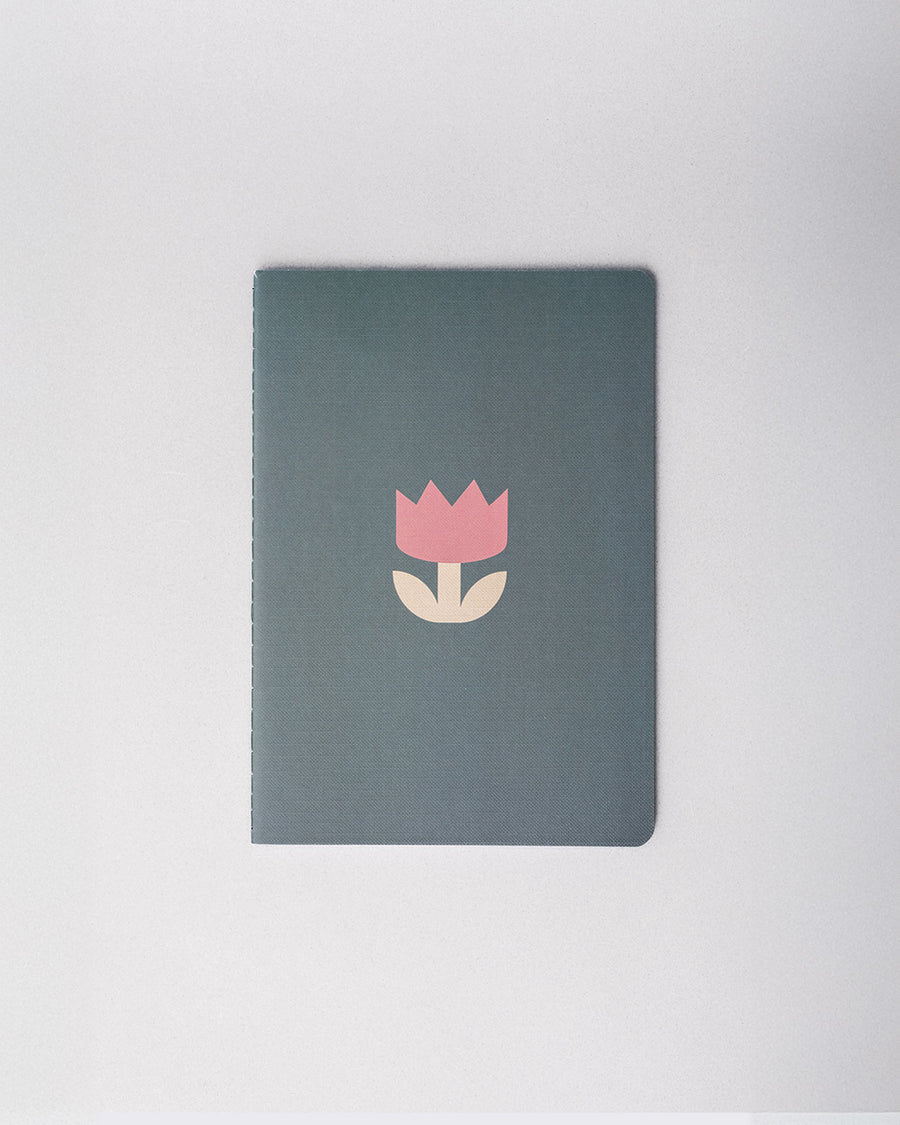 green notebook with pink cartoon-y tulip print