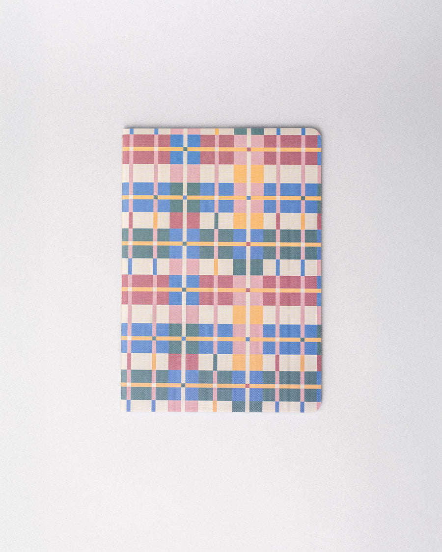 notebook with muted pink, blue, yellow, cream and red plaid print
