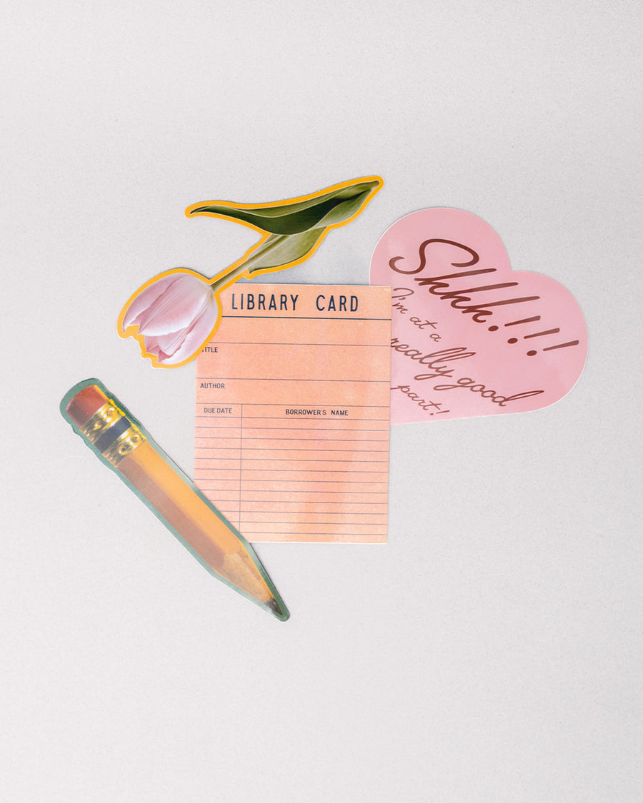 scattered set of 4 big stickers: realistic pencil, realistic pink tulip, library card, and pink heart that says 'shhh!!! i'm at a really good part!