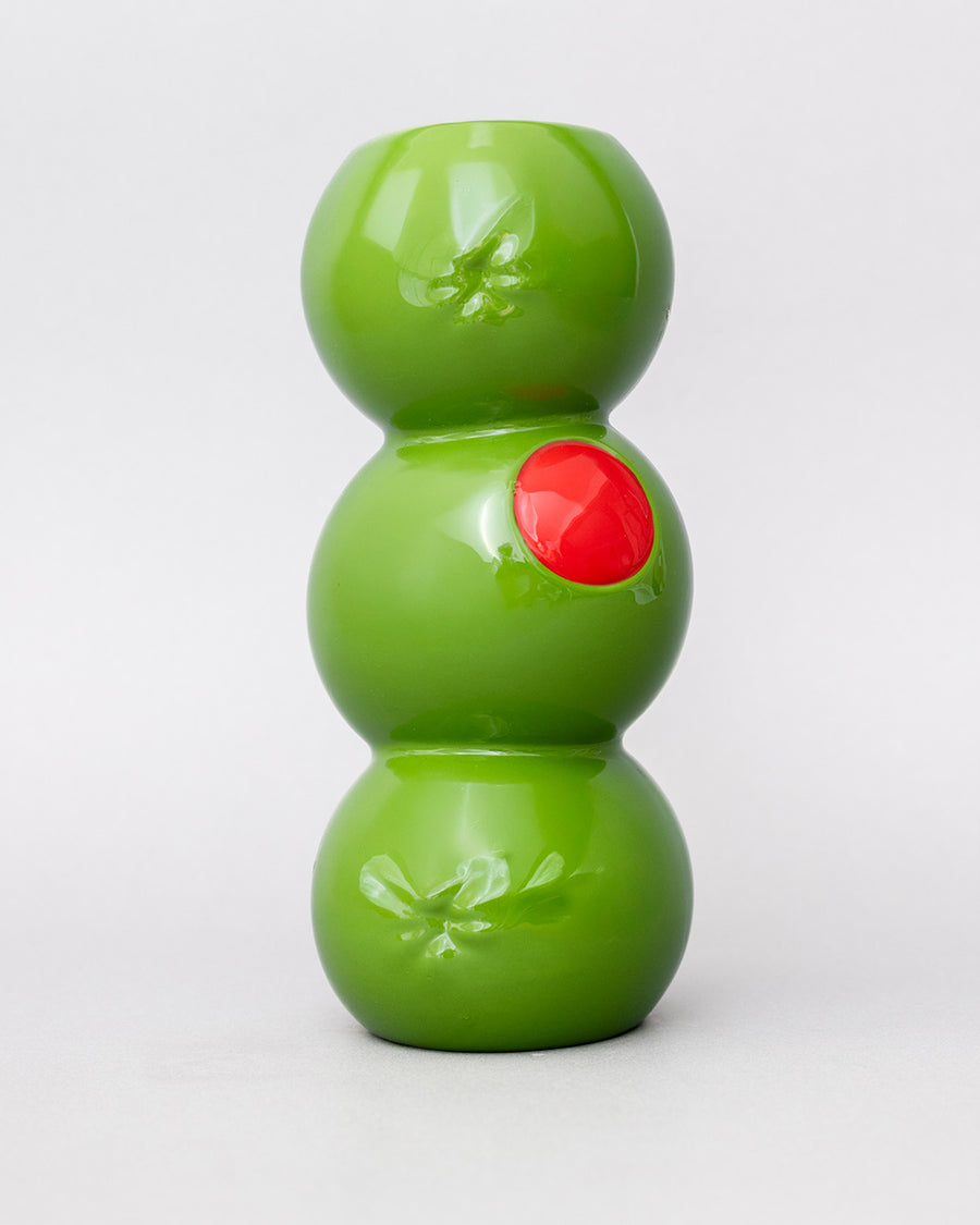 three green olives stacked vase