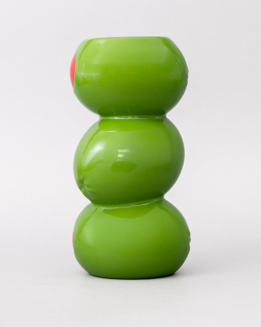 up close of three green olives stacked vase