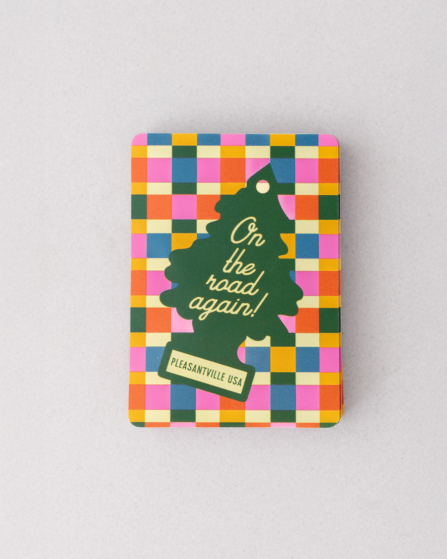 colorful checkered card case with green tree air fresher graphic that says 'on the road again! PLEASANTVILLE USA'