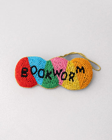 colorful beaded ornament with beaded 'bookworm' across the front