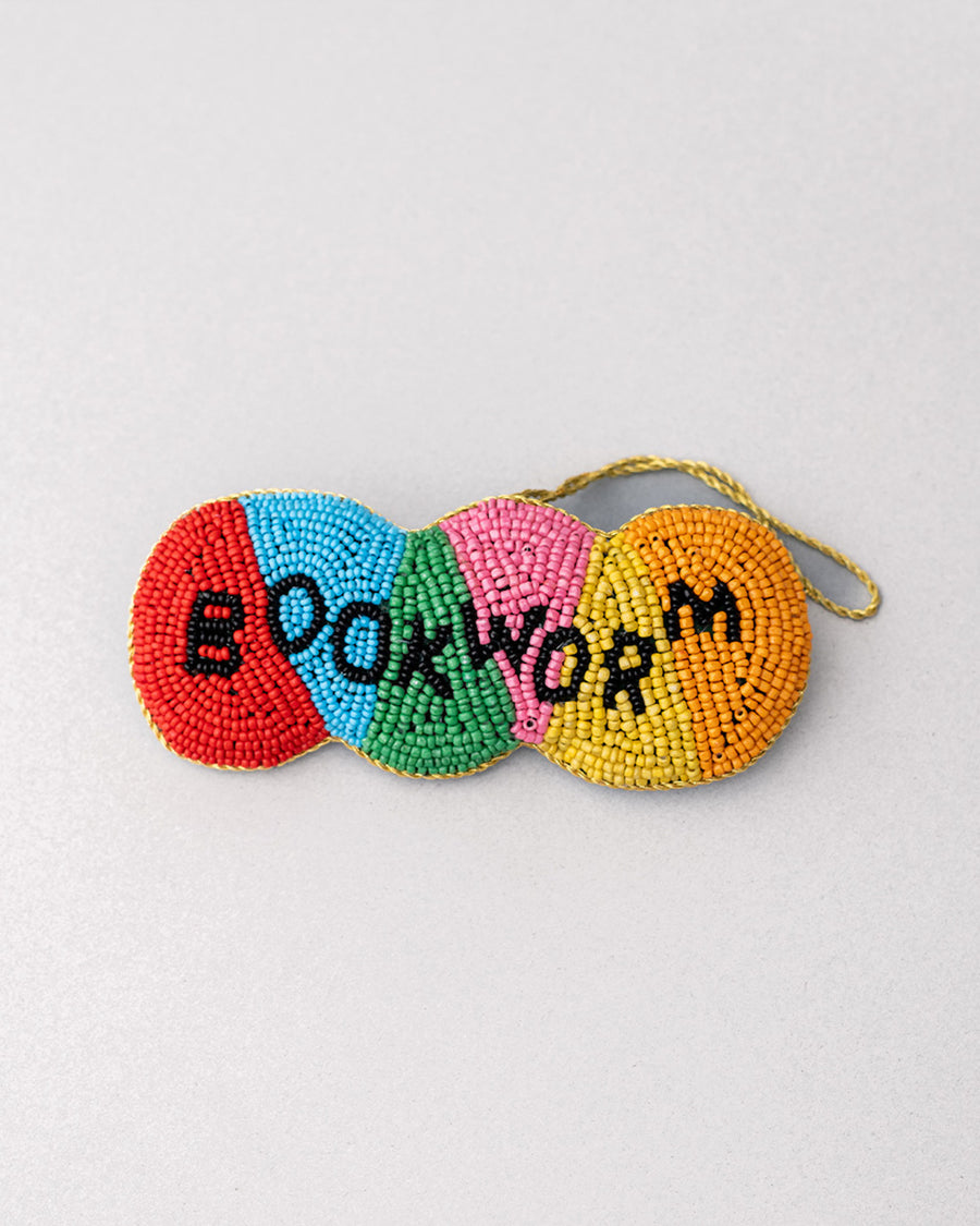 colorful beaded ornament with beaded 'bookworm' across the front