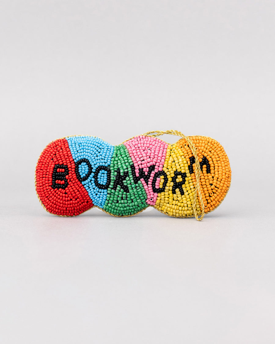 colorful beaded ornament with beaded 'bookworm' across the front with old thread for hanging
