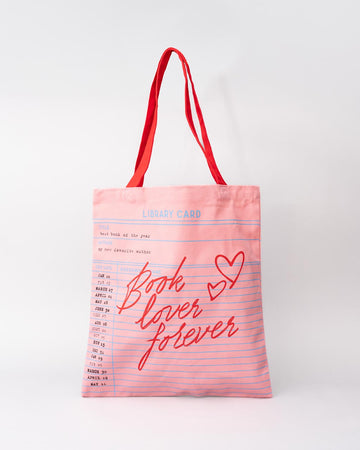 pink library card print tote bag with red 'BOOK LOVERS FOREVER' across the front