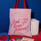 pink library card print tote bag with red 'BOOK LOVERS FOREVER' across the front
