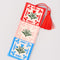 side view of red, pink and blue embroidered folk floral bookmark with red tassel top