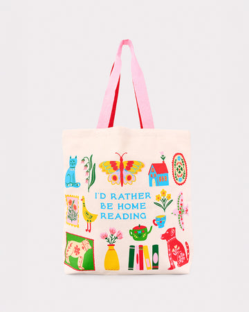 cream tote bag with two-tone pink and red handles and 'I'd rather be reading' typography with colorful folk inspired graphics