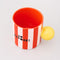 top view of red and white vertical stripe mug with yellow ball handle and double sided typography with 'BONJOUR!' on one side and 'AU REVOIR' on the other