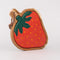 side view of strawberry shaped wooden trivet