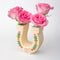 sideview of cream horseshoe ceramic vase with colorful flower trim and 'best of luck' stamp in the center with roses inside