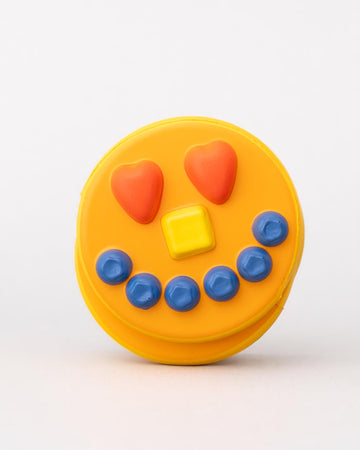 Front view of smiling pancake de stress ball with cute face design