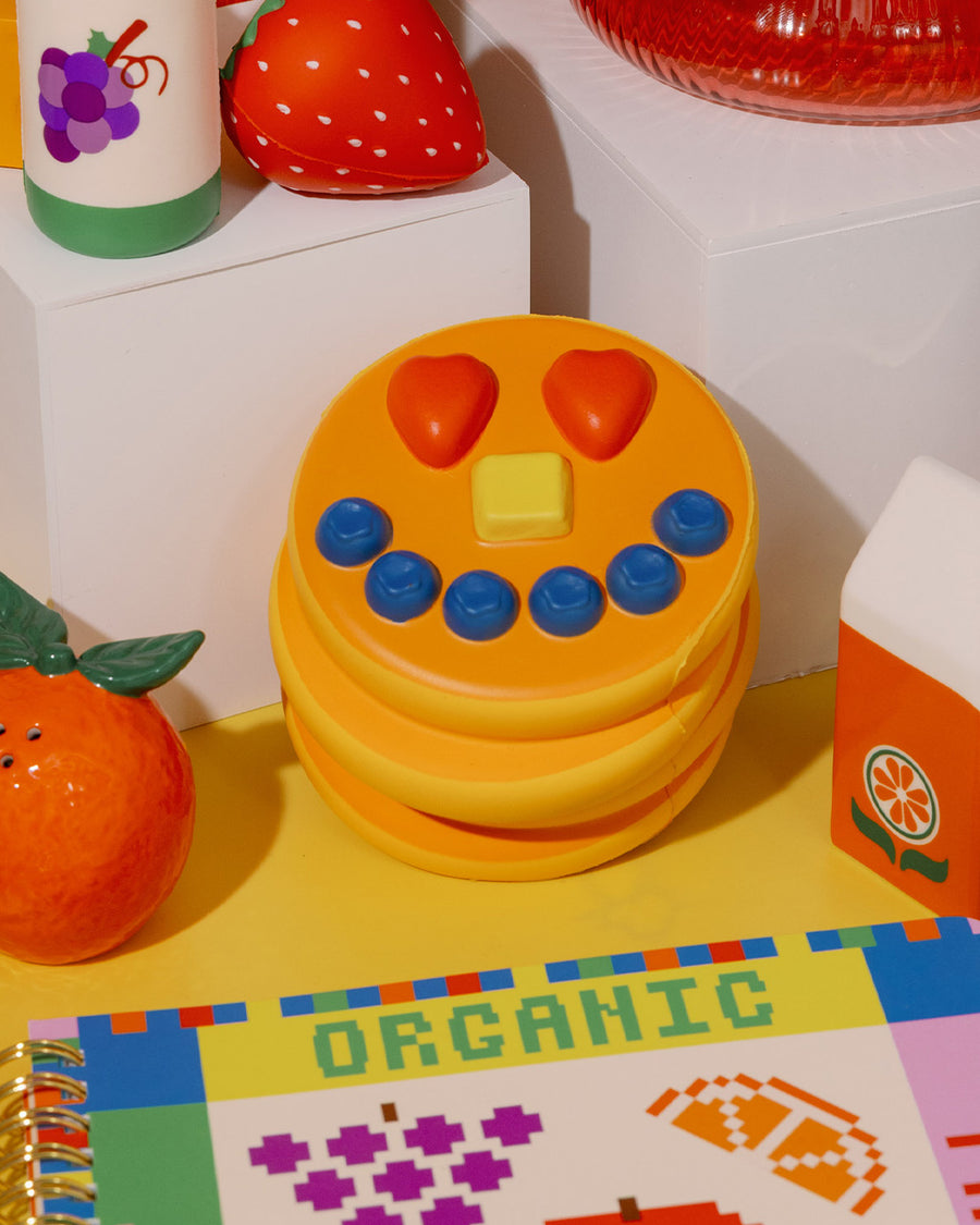 Front view of smiling pancake de stress ball with cute face design