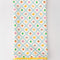 white tea towel with all fruit print and yellow pom trim