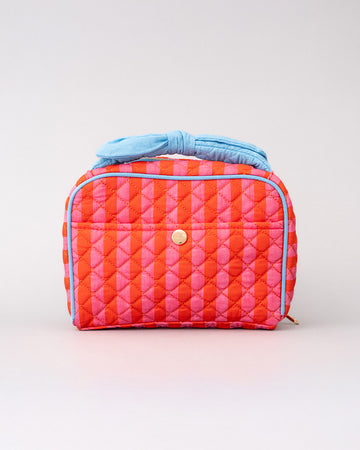 pink and red vertical stripe toiletry bag with light blue bow handle