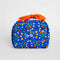 cobalt blue toiletry bag with red bow handle and colorful folk floral print