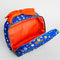 red inside of cobalt blue toiletry bag with red bow handle and colorful folk floral print