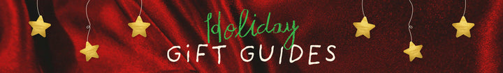 Holiday Gift Guides text on red cloth background with golden stars, festive and colorful ban.do holiday graphic
