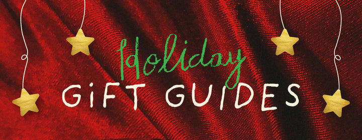 Holiday Gift Guides text on red cloth background with golden stars, festive and colorful ban.do holiday graphic