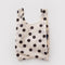 cream baby baggu with black polka dots